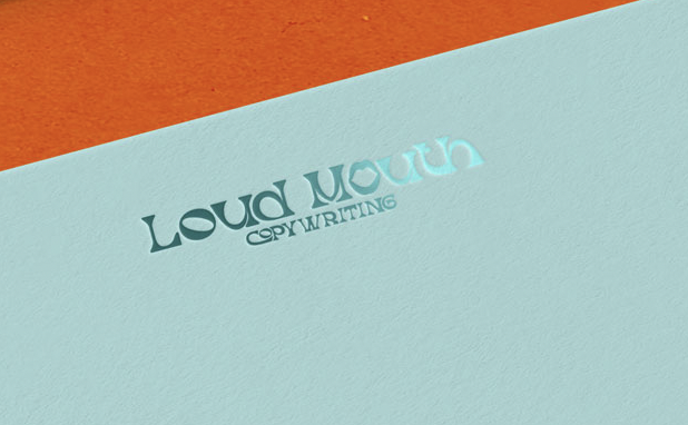 Loud Mouth Copywriting Main Logo in Teal Foil on an aqua paper on a flame red orange background.